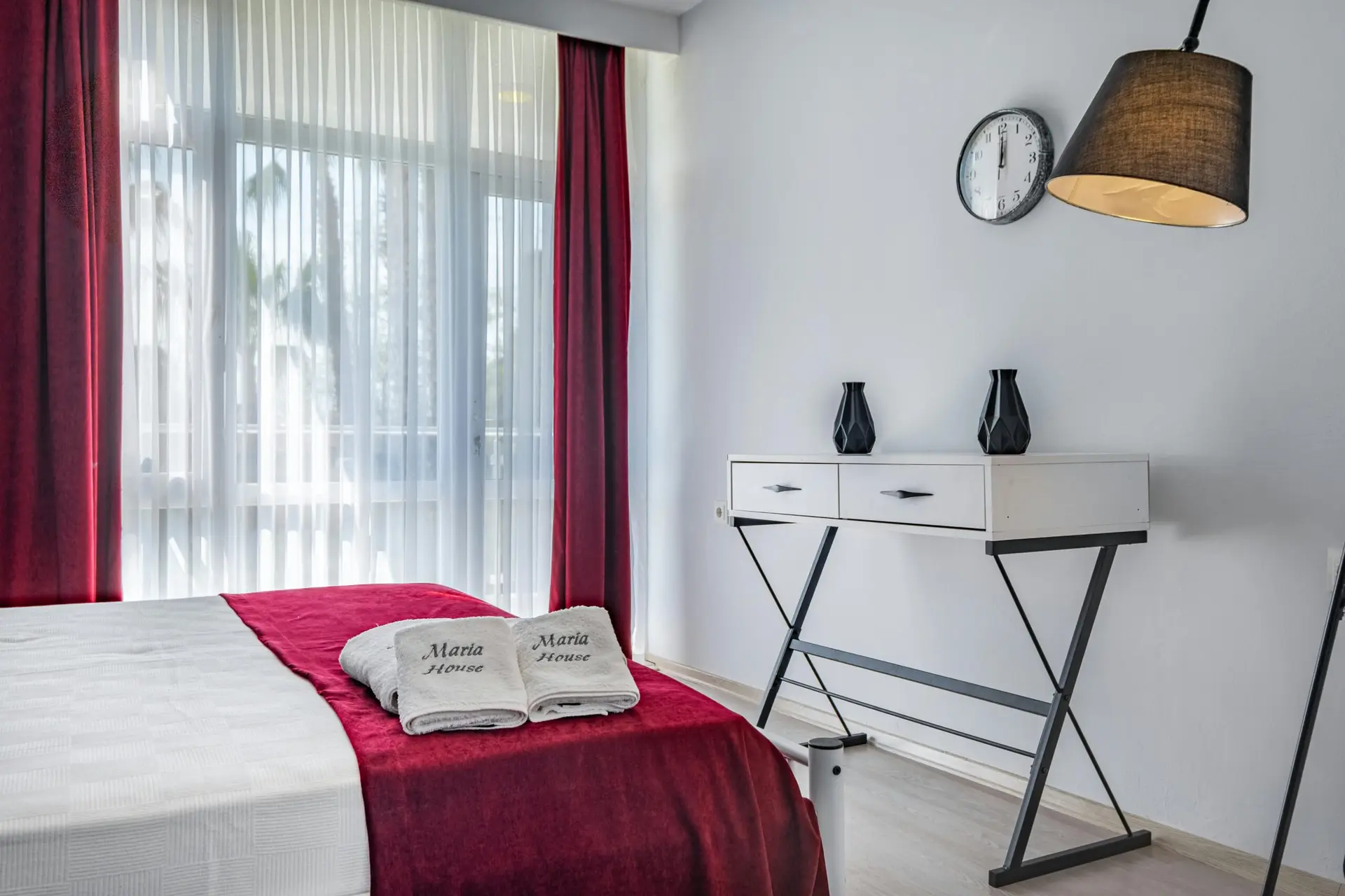 Luxurious hotel room in Antalya with modern furnishings and vibrant red accents.